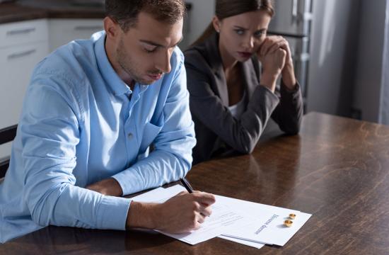 couple with divorce documents on table at home